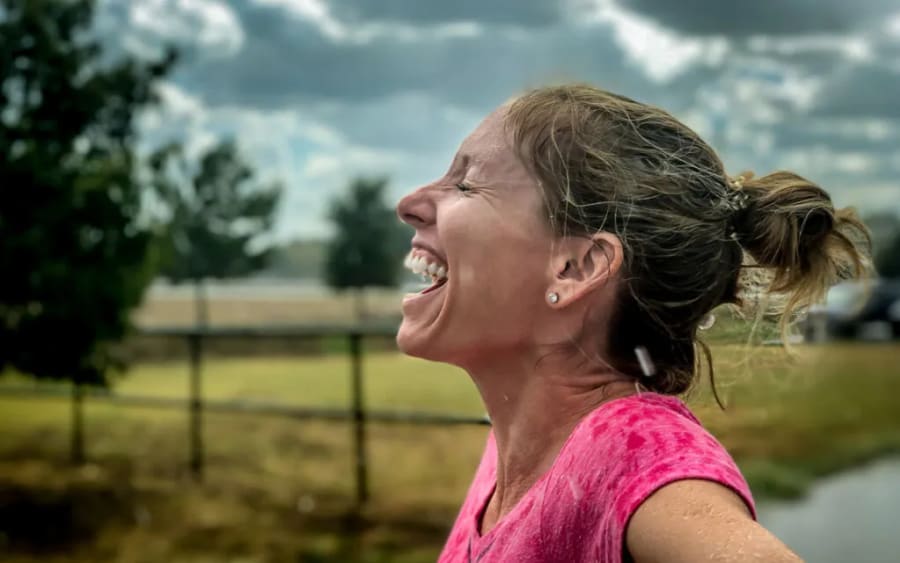 A woman laughing in the rain